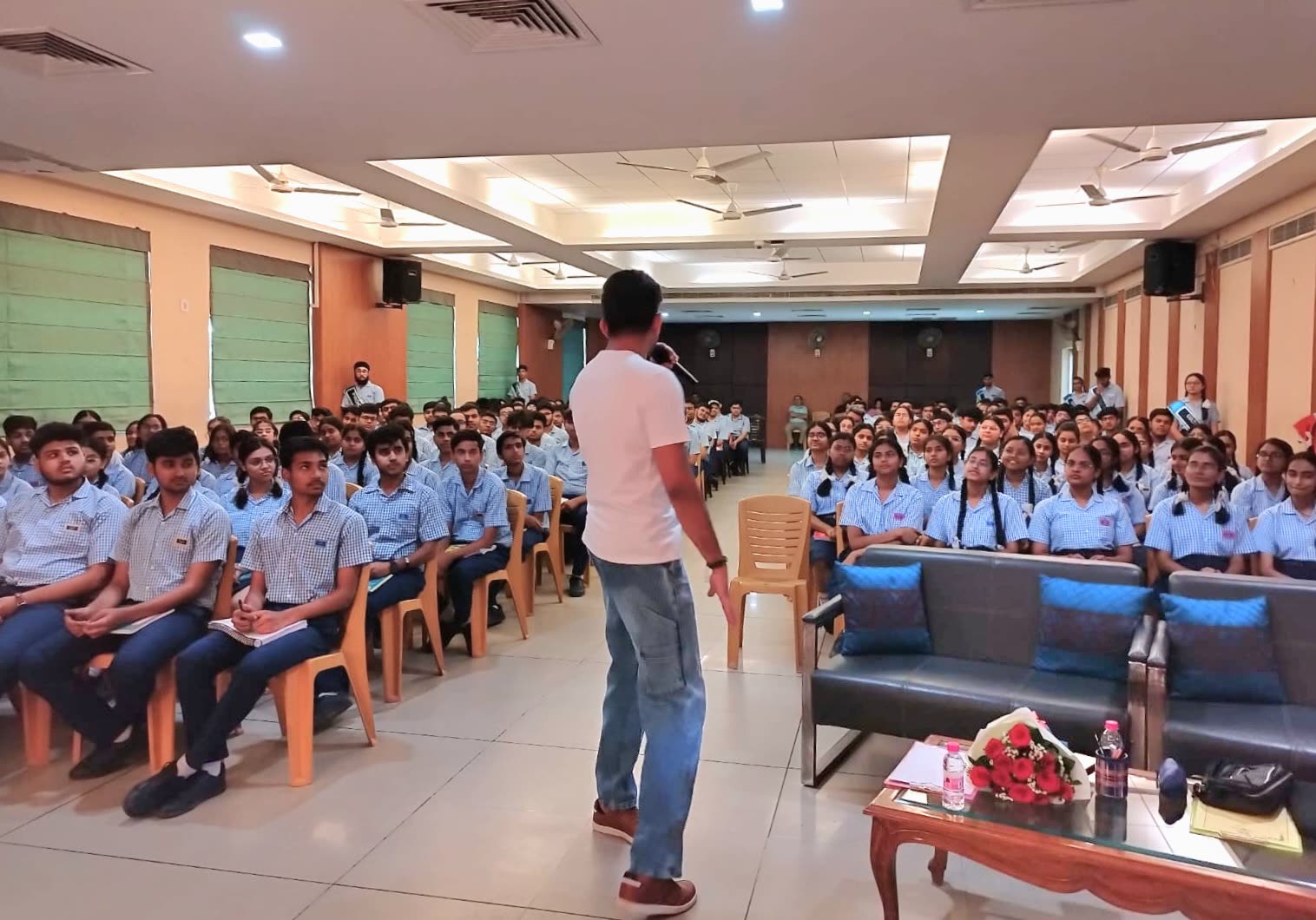 Raman speaking to a full hall